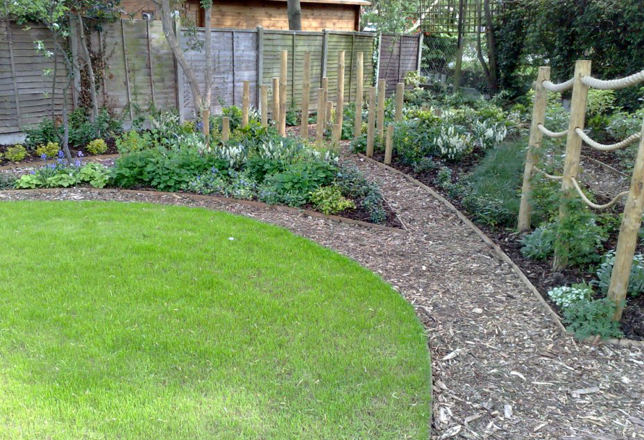 Looking towards the softwood post crossroad feature with path leading into the shady area under the tree